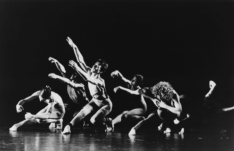 A group of dancers crouching on the ground in Posin's original performance of Waves in 1973